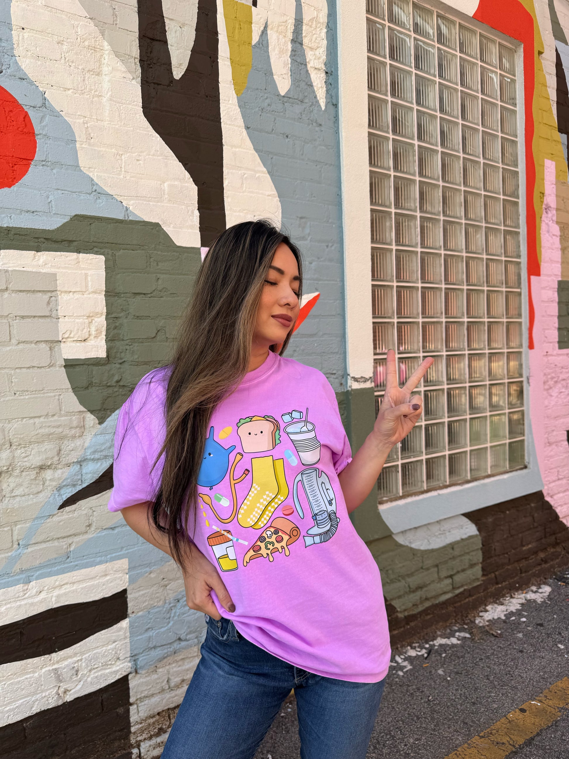 Woman giving the peace sign and wearing a Nurses Tee Shirt - Purple Short Sleeve