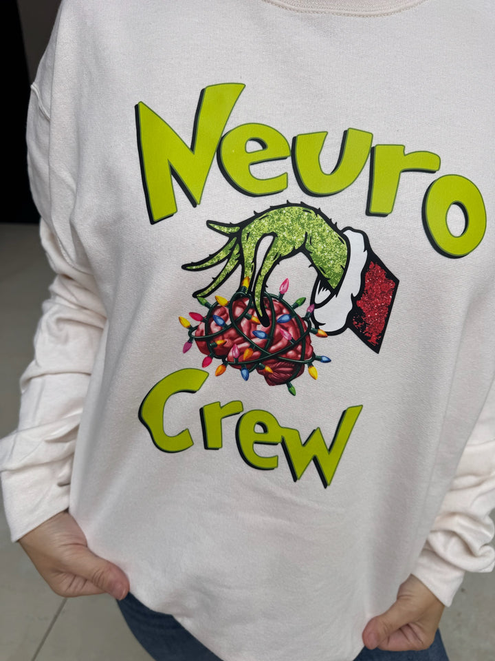 Beige sweatshirt with 'Neuro Crew' design featuring a green hand holding a brain with colorful lights.