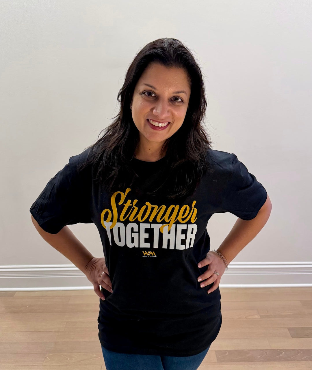 Woman wearing a Women in Medicine® Stronger Together Black Tee Shirt