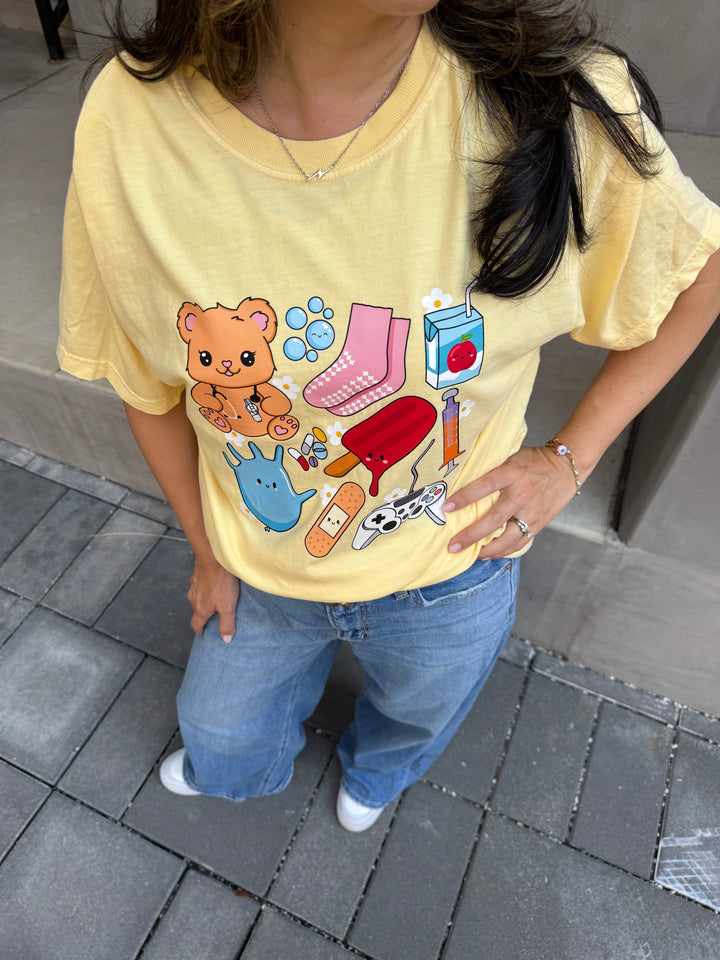 Close up view of collage design of yellow Ladyspinedoc x Scrubhacks Pediatrics Collage Tee Shirt 