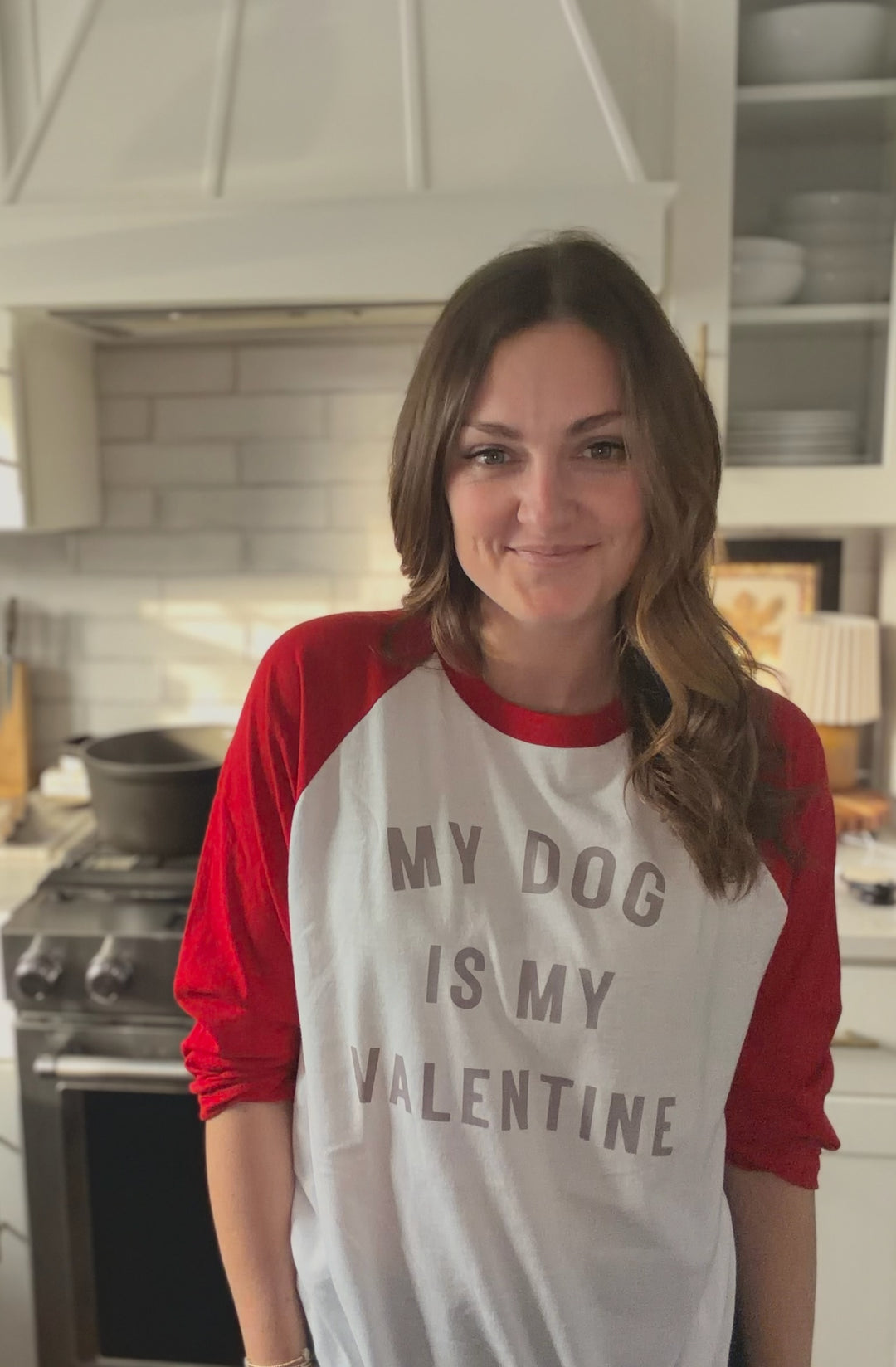 Dr Molly wearing a red and white shirt with 'My dog is my Valentine' text in a kitchen.