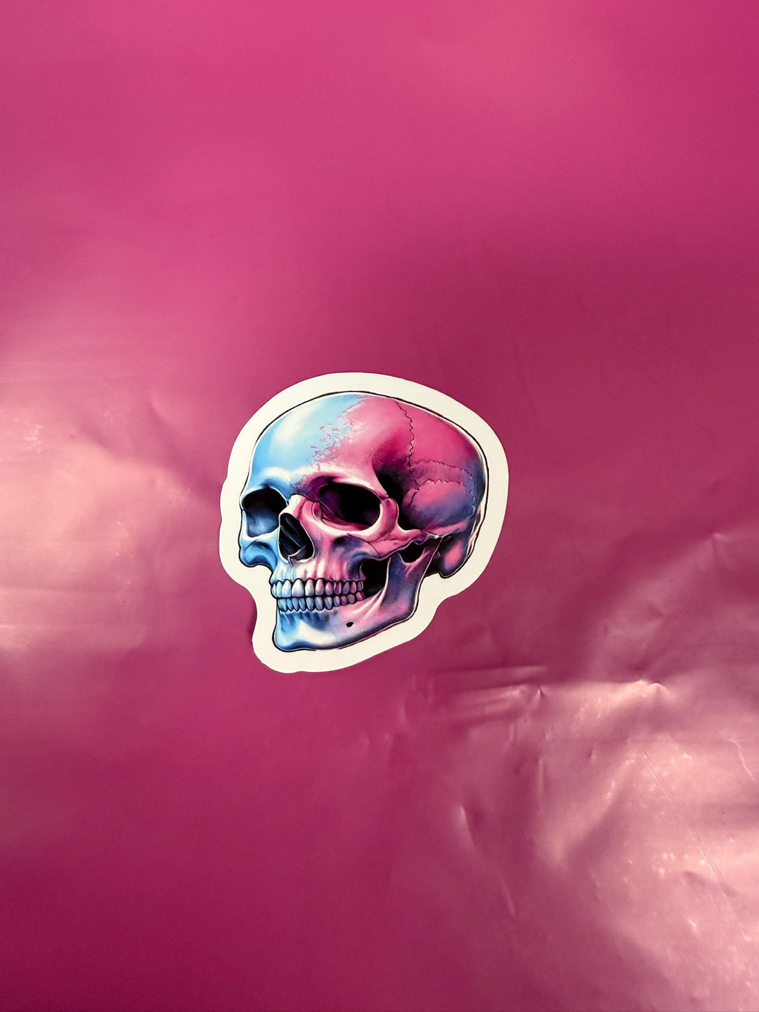 Colorful skull design on a pink background