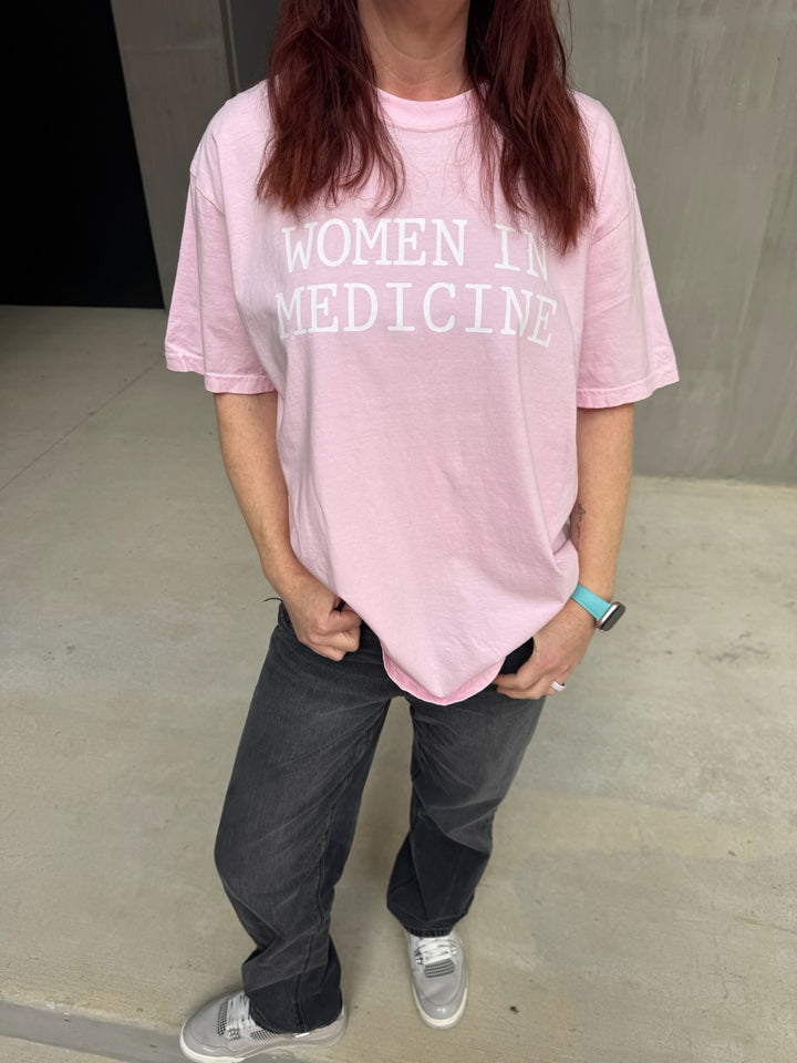 Model wearing pink Women in Medicine Tee Shirt - Empowering Short Sleeve T-Shirt for Healthcare Pros
