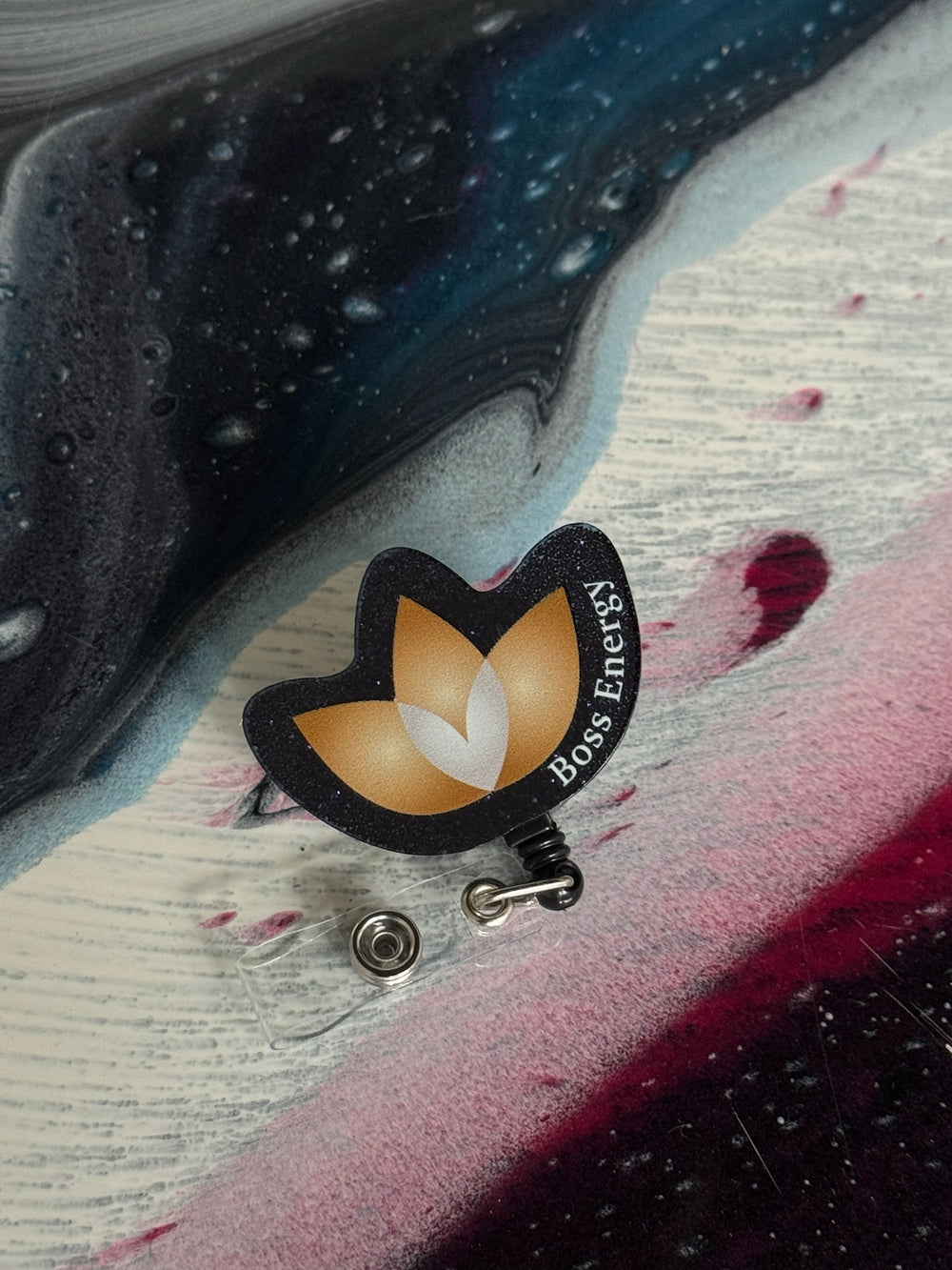 Confidence Doc badge holder with a lotus design and 'Boss Energy' text on a colorful surface.