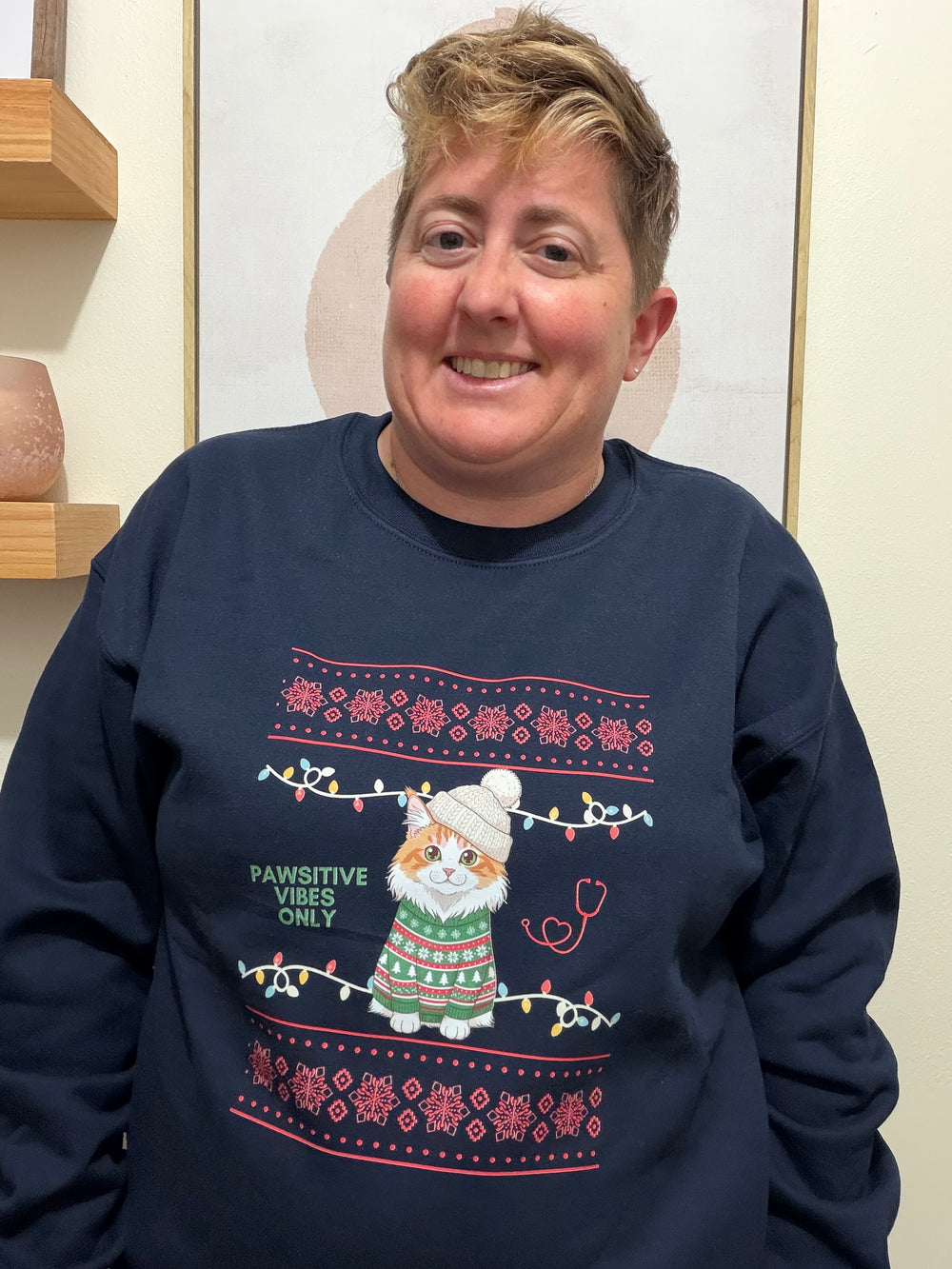 Dr. Beachgem wearing a navy blue sPawsitive Vibes Only Cat Christmas Sweatshirt featuring a cat and text.
