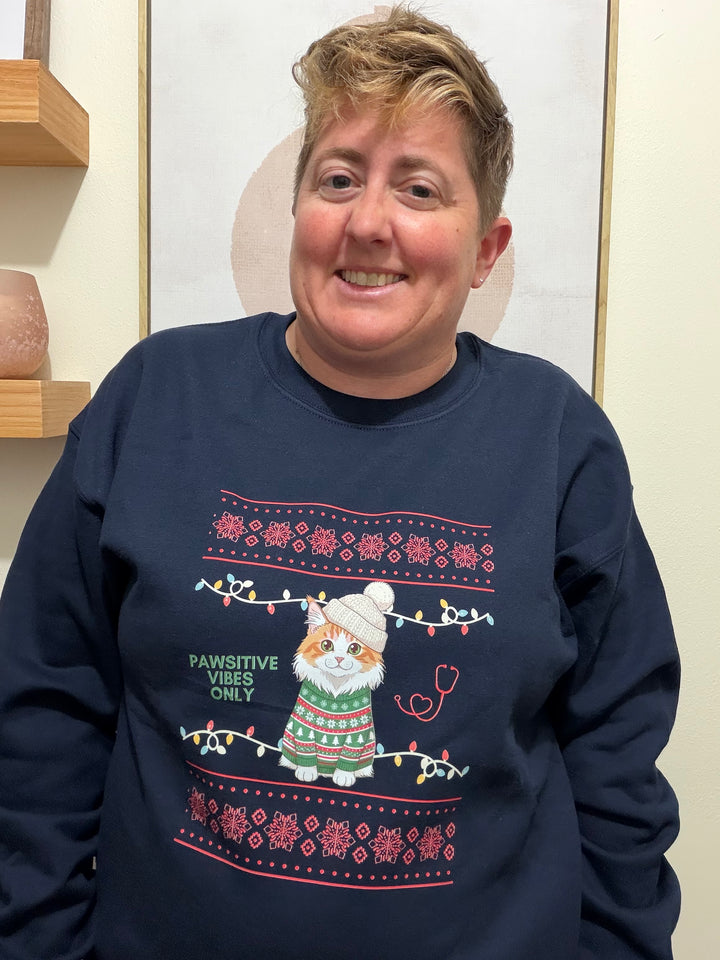 Dr. Beachgem wearing a navy blue sPawsitive Vibes Only Cat Christmas Sweatshirt featuring a cat and text.