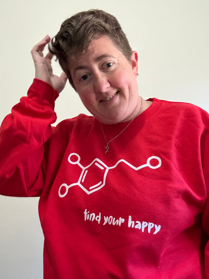 Dr. Beachgem wearing a red crewneck sweatshirt with a white dopamine molecule graphic and “find your happy” tagline in playful brush font.
