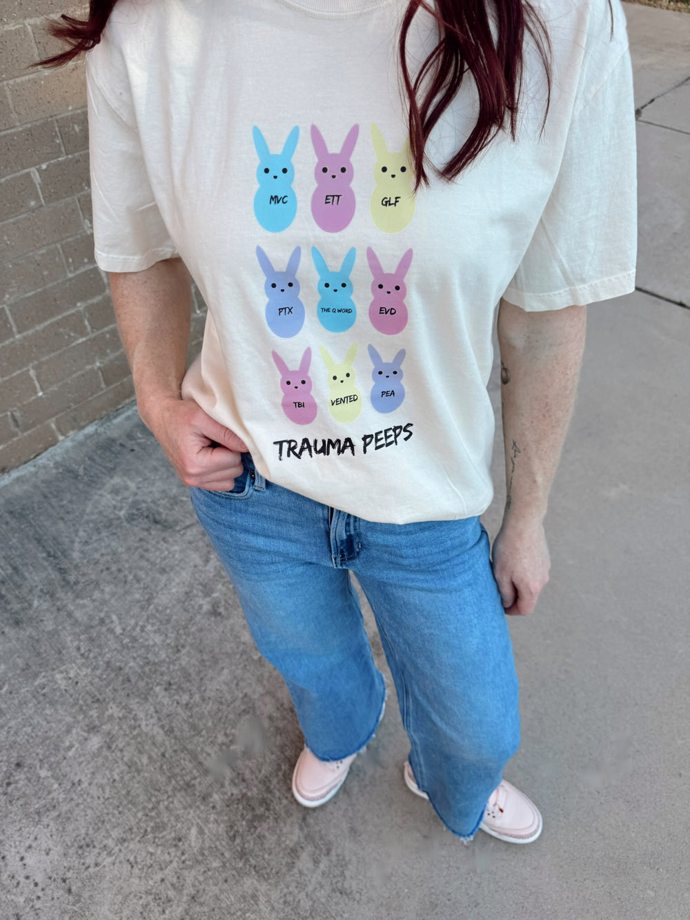 Close up of Ladyspinedoc wearing the Trauma Squad Tee – Beige Short Sleeve with Pastel Bunnies and Trauma Lingo