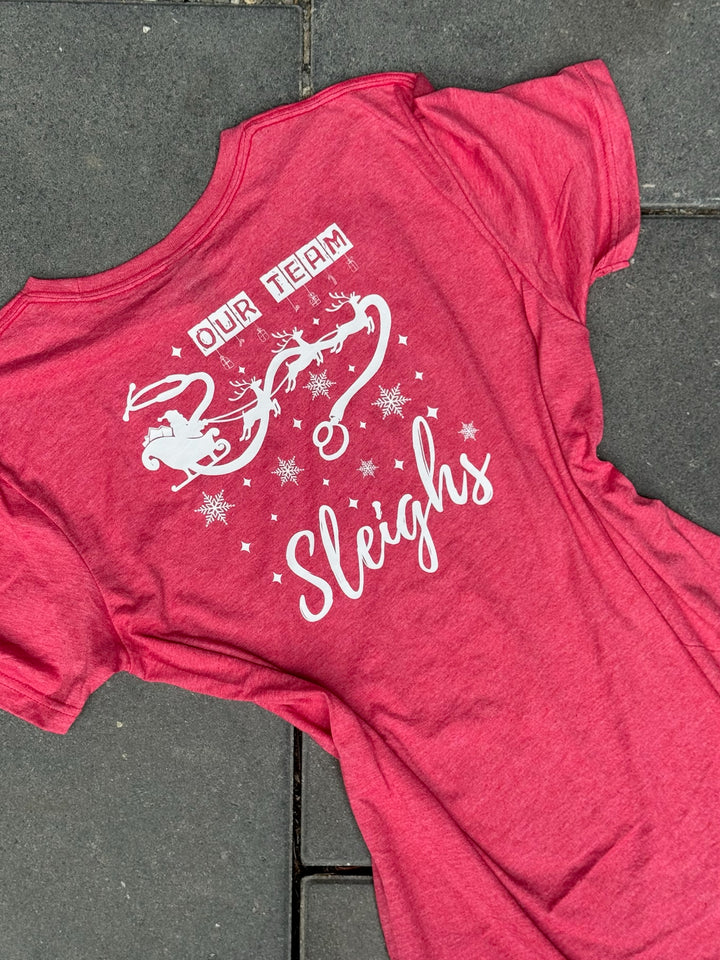 Red t-shirt with white graphic and text on a gray pavement background