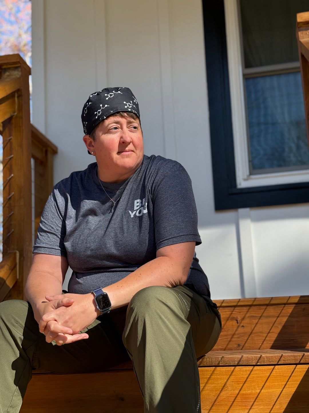 Right center view of Dr. Beachgem wearing the Ladyspinedoc x Dr. Beachgem Code Cart Cap - Black Scrub Hat with White Epinephrine (Adrenaline) Molecule Design