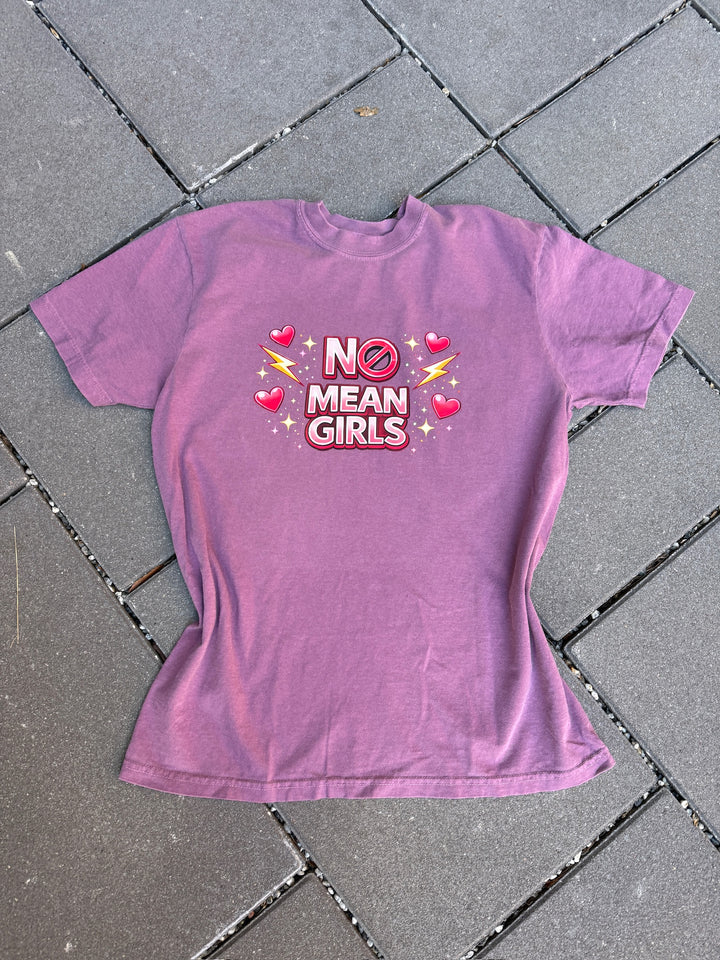 Purple t-shirt with 'No Mean Girls' text on a tiled floor