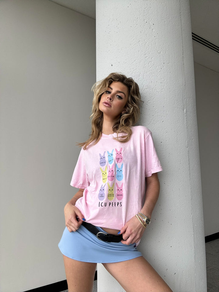 Woman wearing the ICU Squad Tee – Pink Short Sleeve with Pastel Bunnies and ICU Lingo