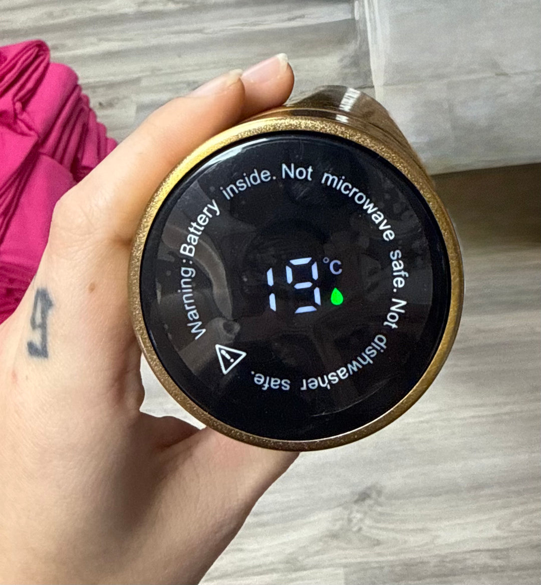 Close up of LED temperature display on gold Bosom Smart Water Bottle with Breast Design  