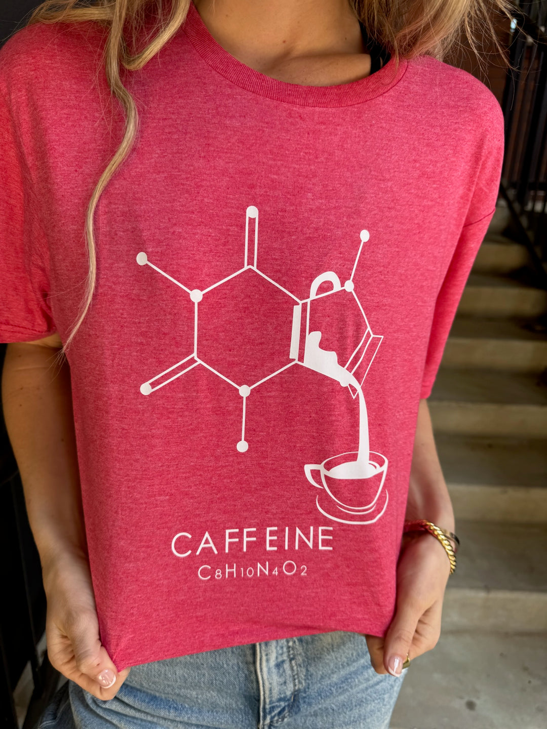 Red t-shirt with caffeine molecule design worn by a person