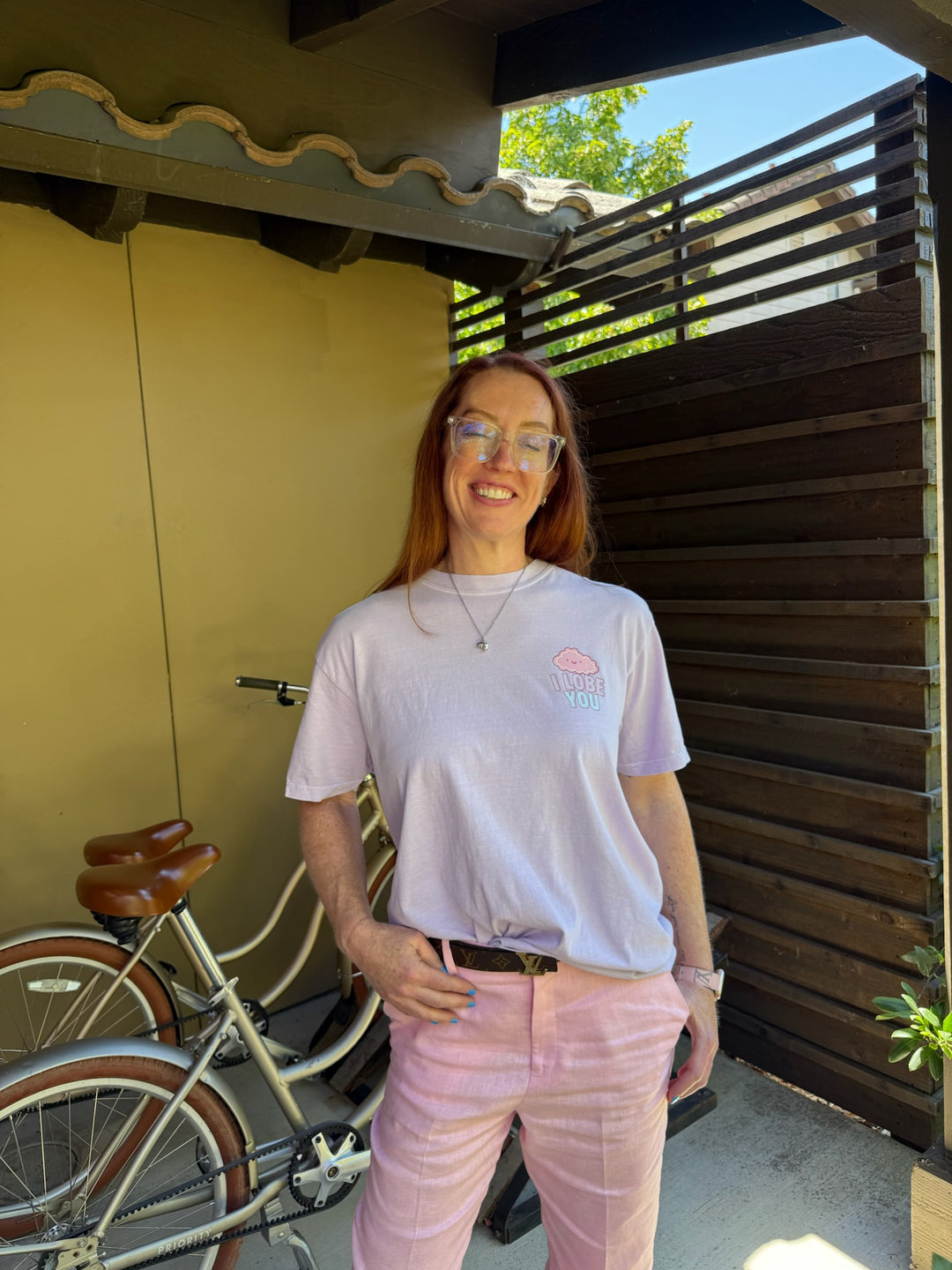 Ladyspinedoc wearing the Silver Brain Necklace and I Lobe You brain tee with bikes in background