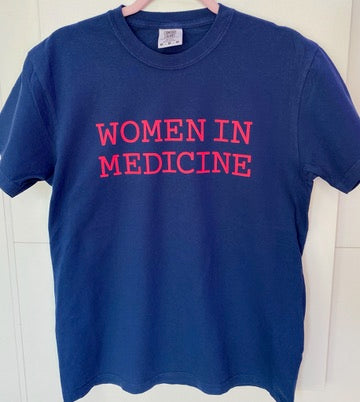 Blue t-shirt with 'WOMEN IN MEDICINE' text in hot pink on a white background