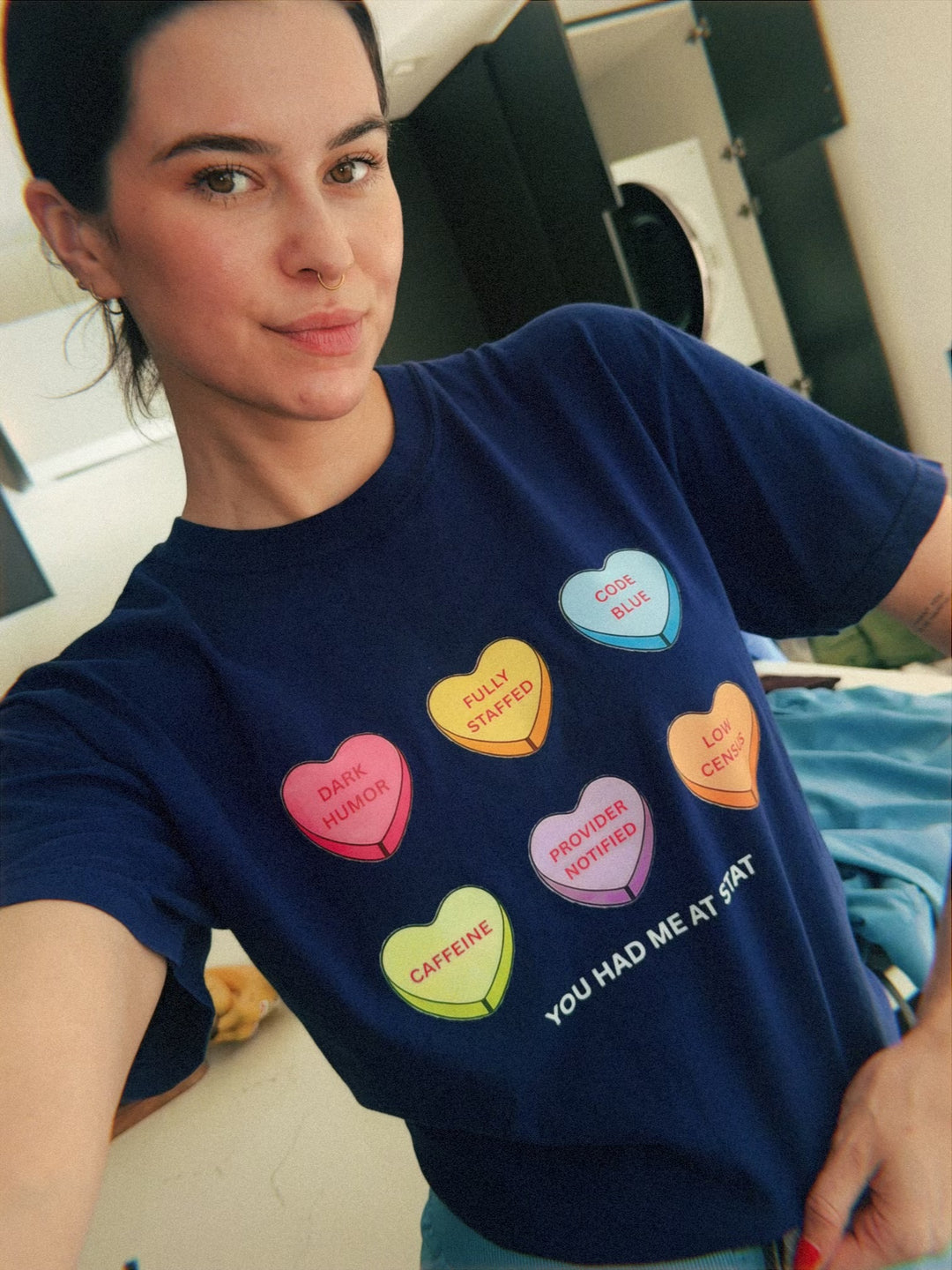 Scrubhacks wearing Navy Nurse Tee with colorful Candy Hearts and You Had Me At Stat motto