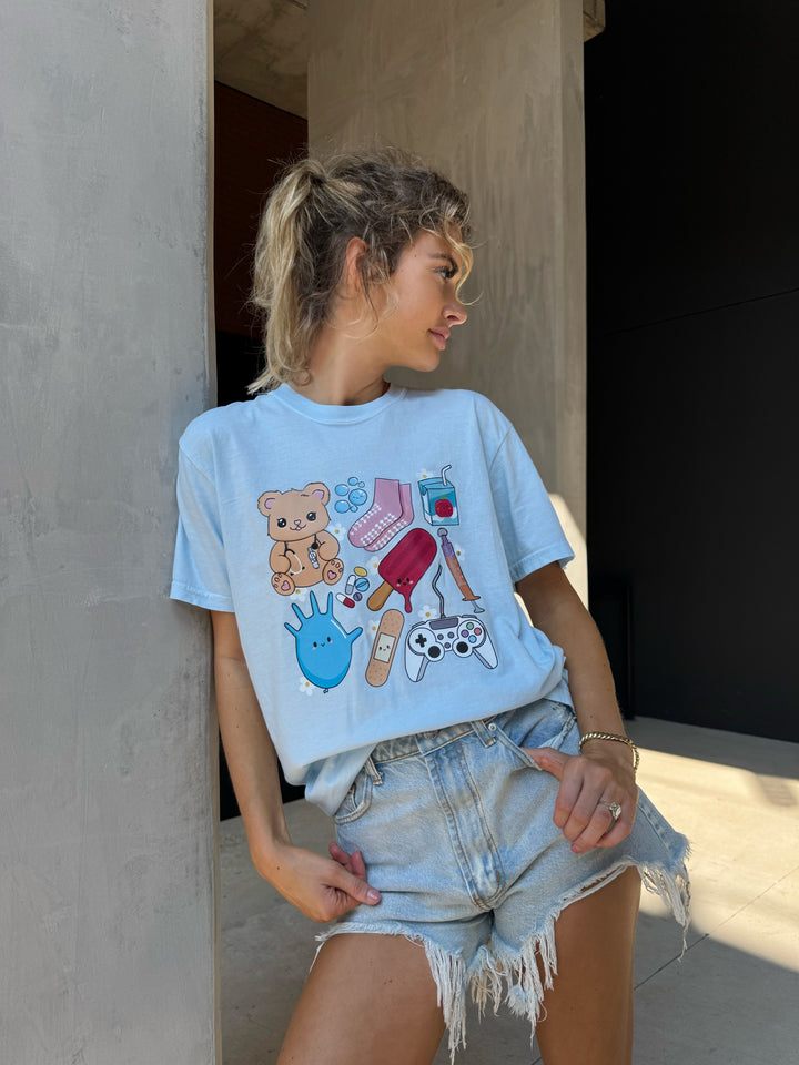 Model wearing light blue Ladyspinedoc x Scrubhacks Pediatrics Collage Tee with cut off jeans