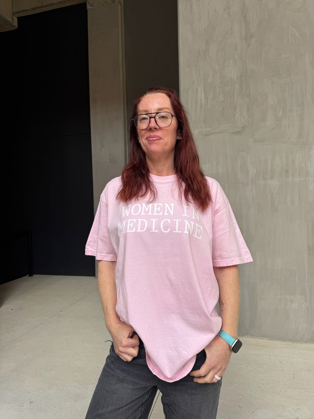 Model wearing pink Women in Medicine Tee Shirt - Empowering Short Sleeve T-Shirt for Healthcare Pros