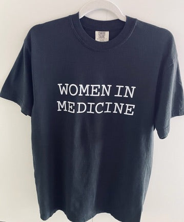 Black t-shirt with 'WOMEN IN MEDICINE' text on a white background