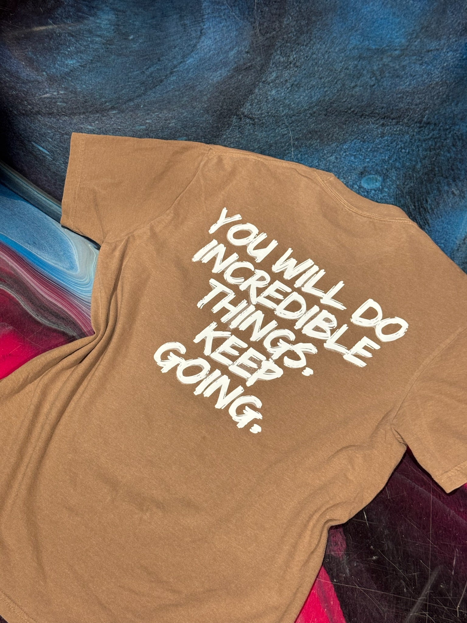 Back flat lay of The Incredible Tee Shirt - Brown Shirt with Motivational "YOU WILL DO INCREDIBLE THINGS. KEEP GOING." Motto