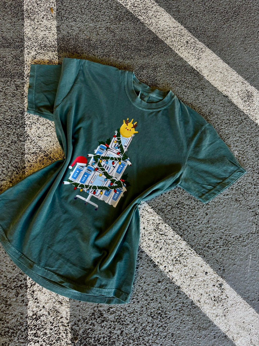Flat lay of green Nurse Christmas Tree Tee Shirt with IV Pump Design