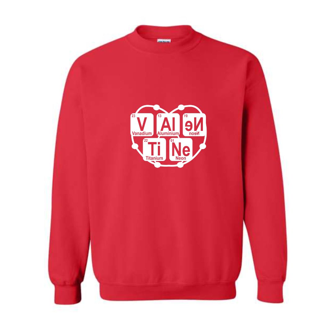 Flat lay of red Atomic Attraction crewneck sweatshirt featuring periodic table spelling “Valentine” with orbiting heart atom design