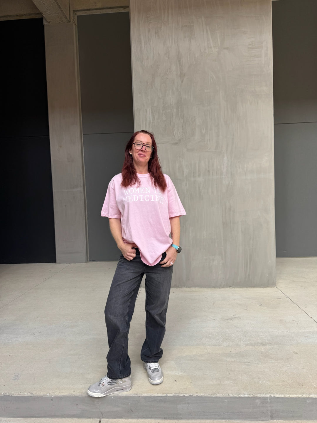 Model wearing pink Women in Medicine Tee Shirt - Empowering Short Sleeve T-Shirt for Healthcare Pros