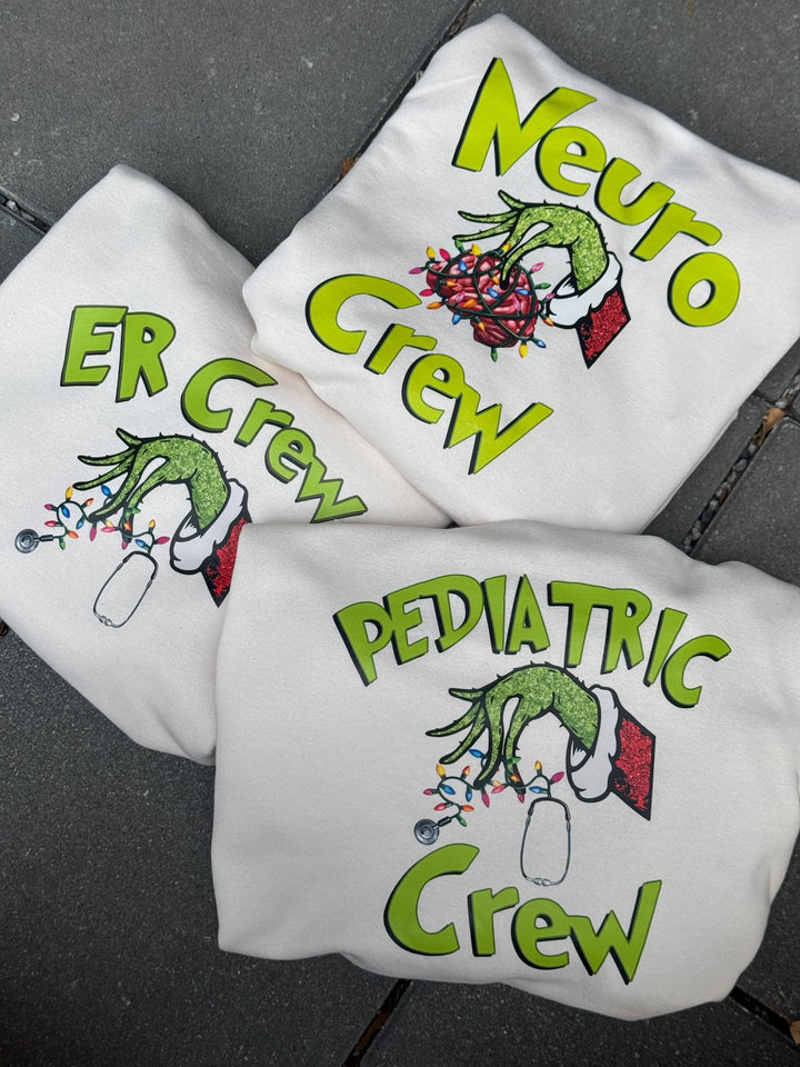 Medical sweatshirts with green text and graphics on a dark surface