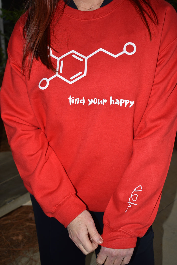 Dr. Betsy Grunch - Ladyspinedoc - wearing the red Dopamine Molecule Sweatshirt, and showing off the Dr. Beachgem logo which symbolizes the heart of medicine printed on the inner left sleeve.
