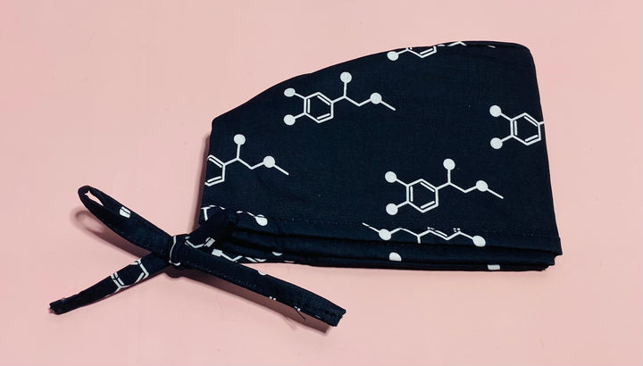 Code Cart Cap - Black Scrub Hat with White Adrenaline Design on a light pink background