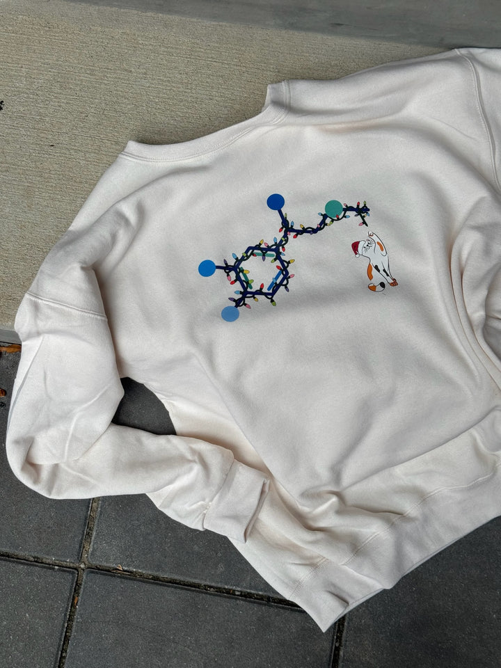 White sweatshirt with adrenaline molecular cat design on a gray floor