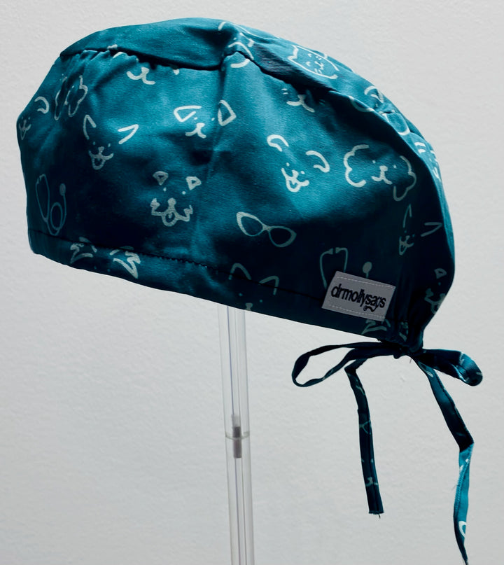 Green scrub cap with white patterns on a gray background