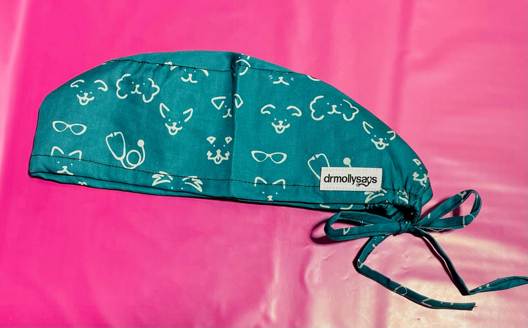 Green scrub cap with white patterns on a pink background