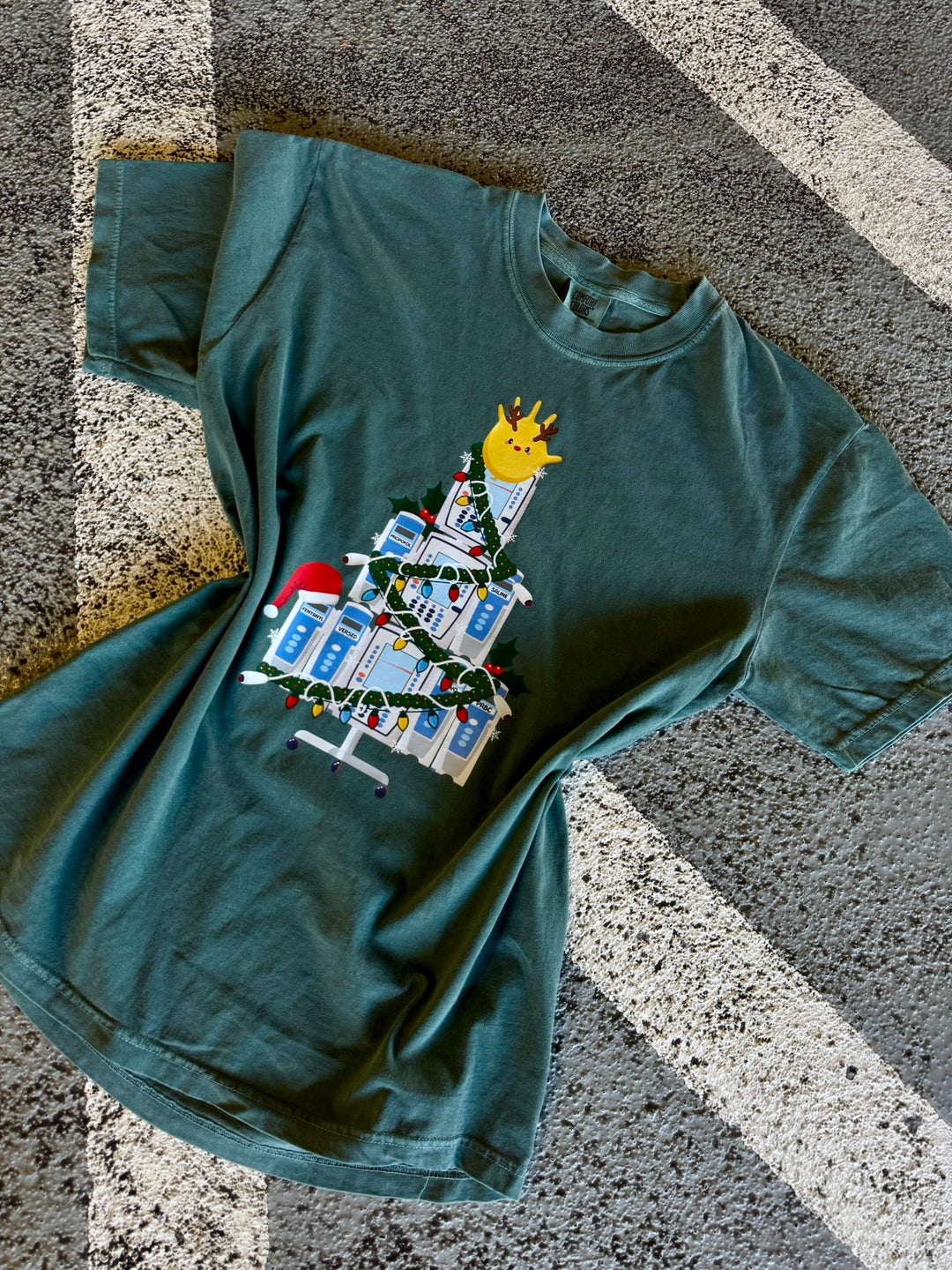 Green Nurse Christmas Tree Tee Shirt with IV Pump Design on a textured surface
