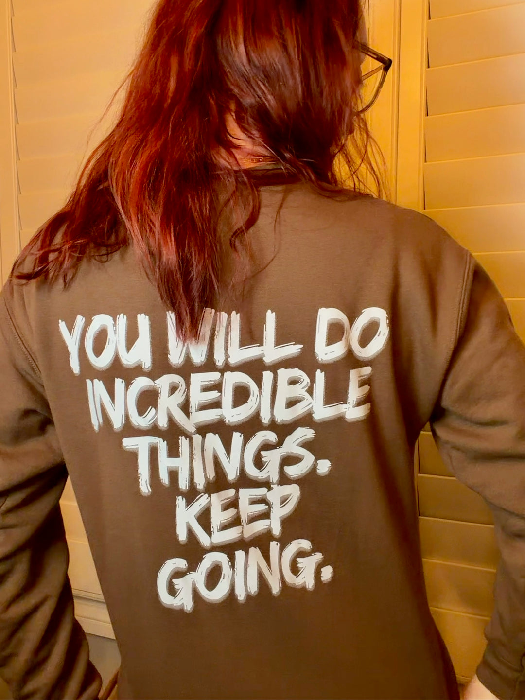 Ladyspinedoc wearing a brown Incredible sweatshirt with motivational You Will Do Incredible Things. Keep Going. in her closet.