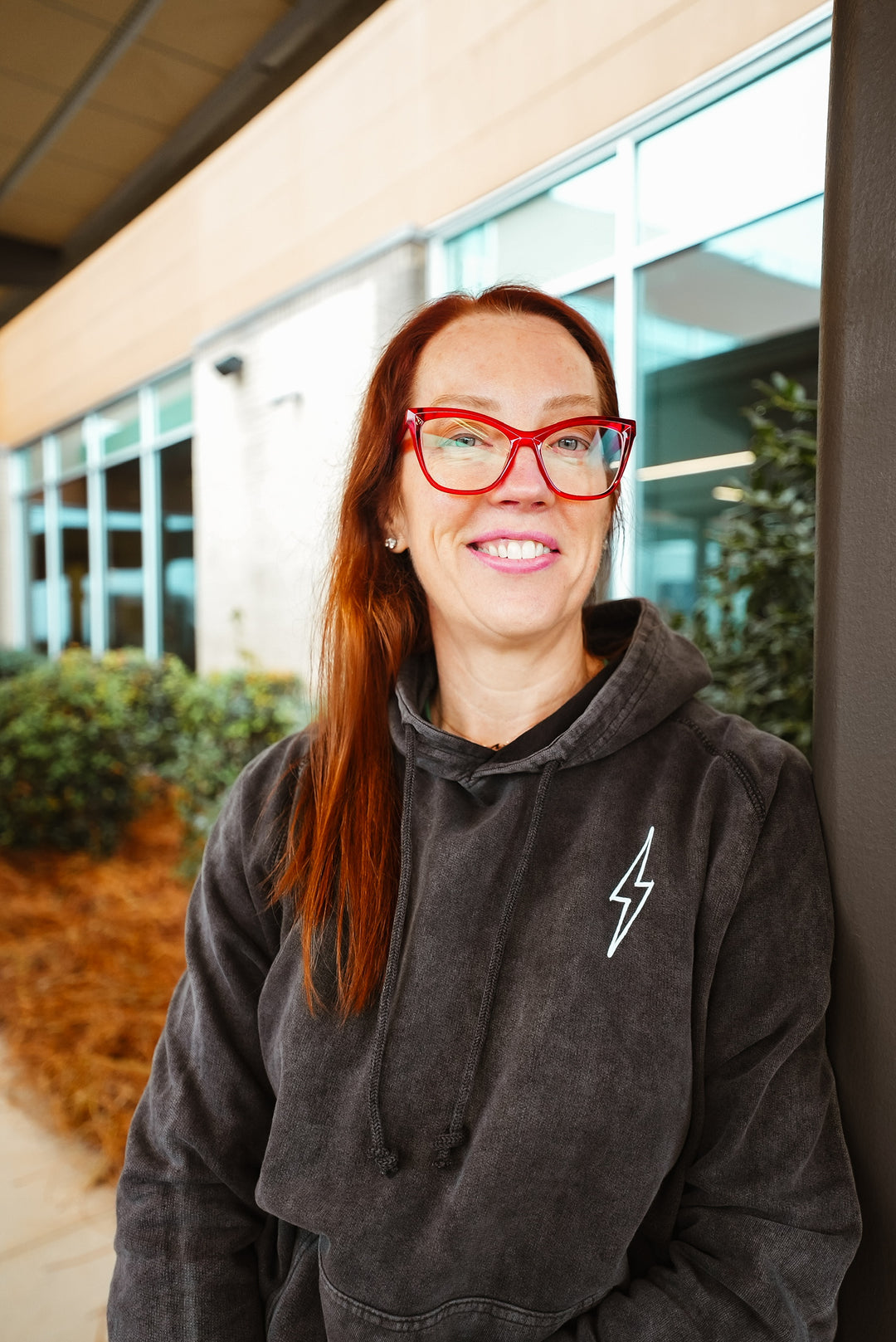 Dr. Betsy Grunch (Ladyspinedoc) facing forward wearing the dark gray Incredible Hoodie and showcasing front lightning bolt detail
