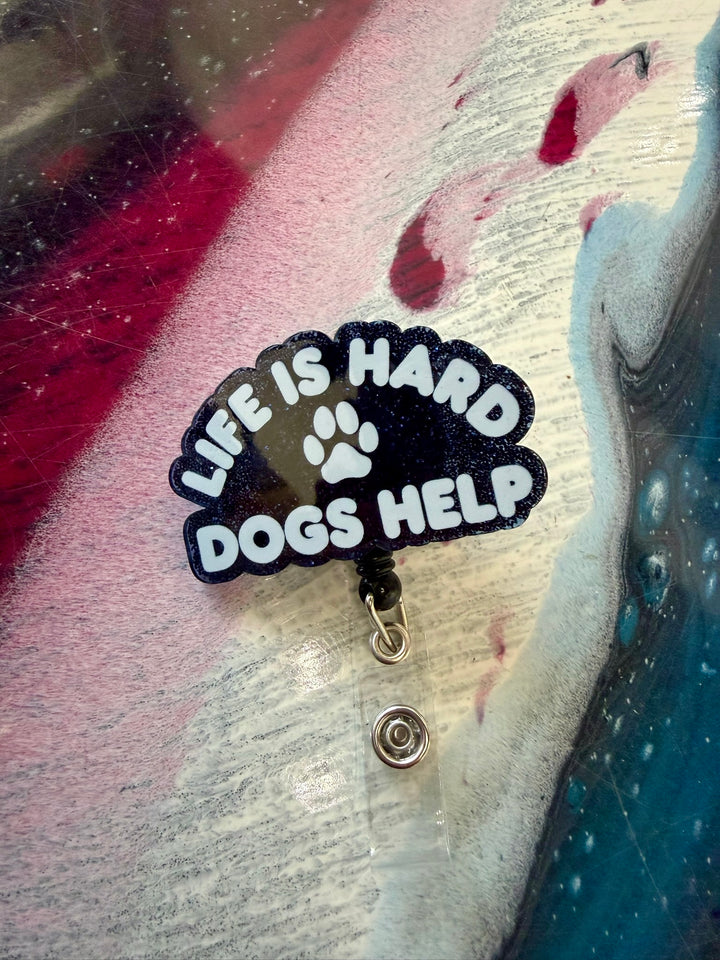 Badge holder with 'Life is Hard, Dogs Help' text on a textured background