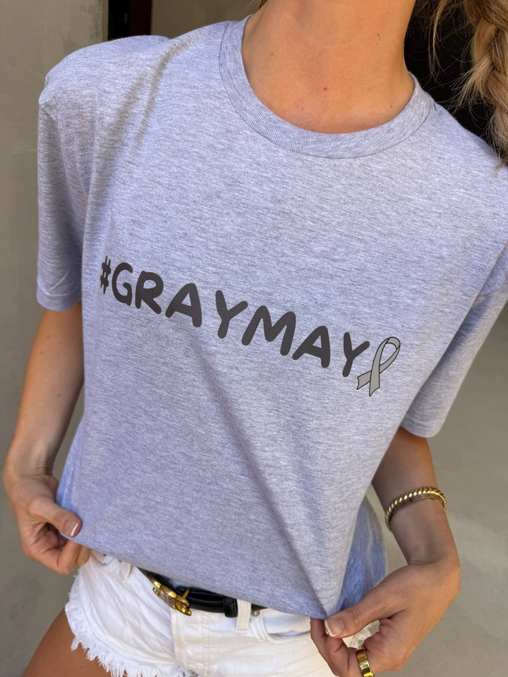 Person wearing a gray t-shirt with '#GRAYMAY' text and a ribbon symbol.