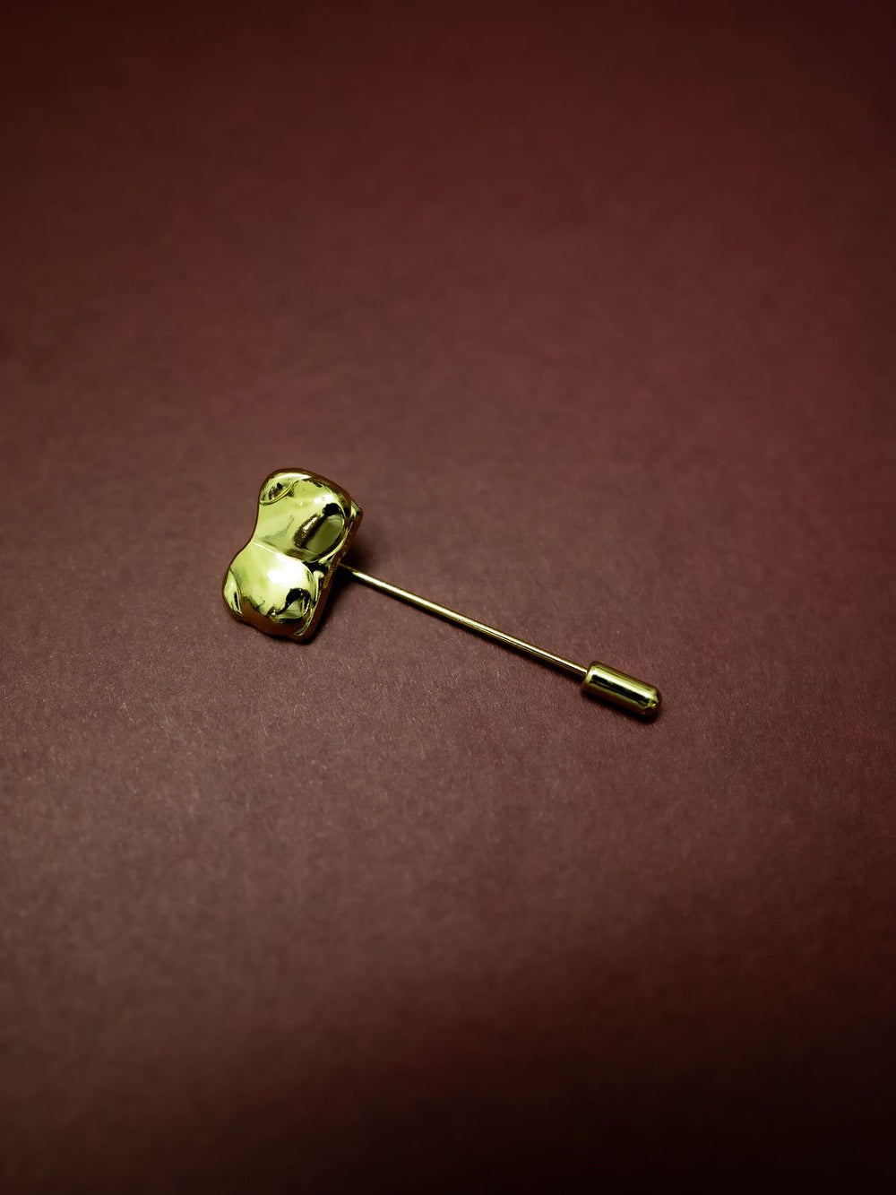 Gold Bust / Breast / Bosom Stick Pin on burgundy background