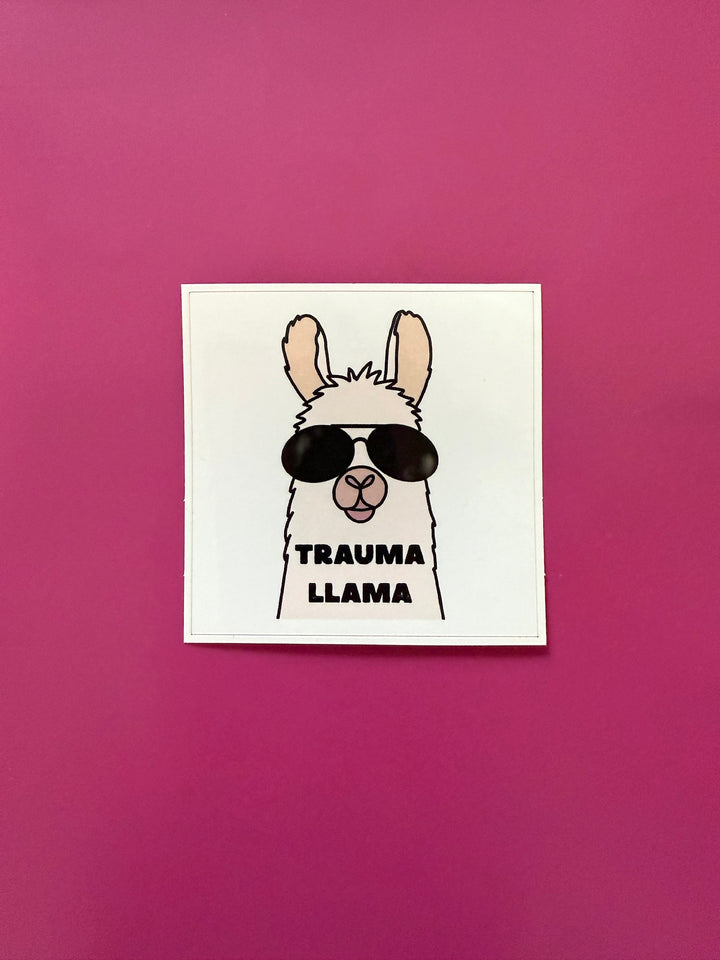 Sticker with a llama wearing sunglasses and 'TRAUMA LLAMA' text on a pink background