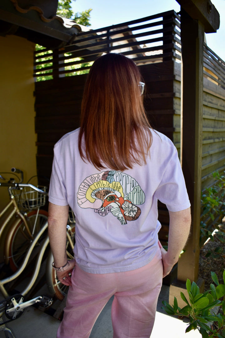 Ladyspinedoc showing off the design on the back of the I Lobe You Brain Anatomy Tee with bikes in background