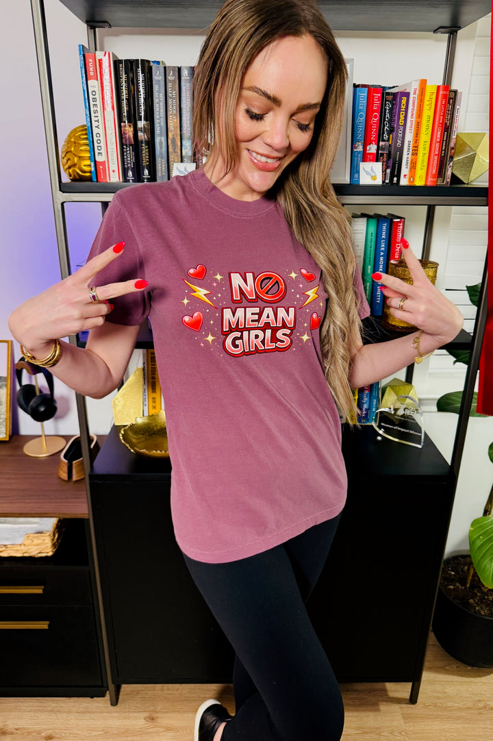 Dr. Brain Barbie wearing a burgundy No Mean Girls Tee in front of a bookcase