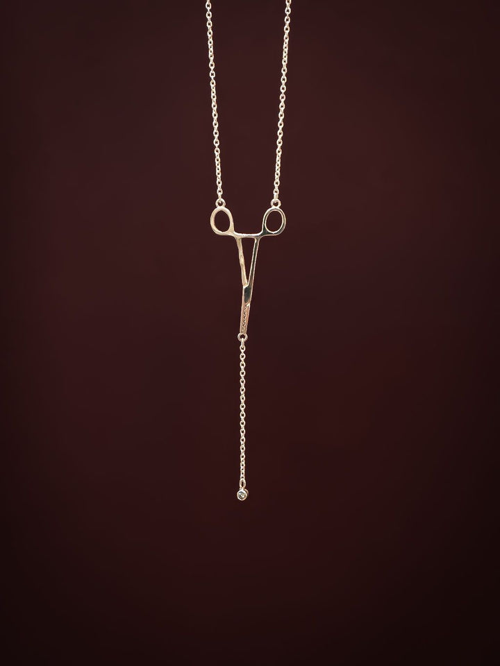 Close-up of silver Erin Necklace: Hemostat With Diamond Drop
