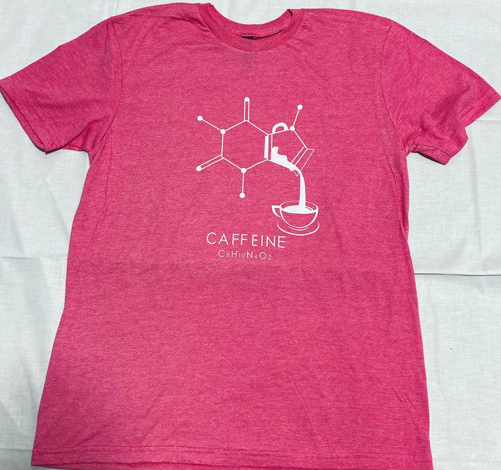Pink t-shirt with white molecule graphic and 'CAFFEINE' text on a light gray background