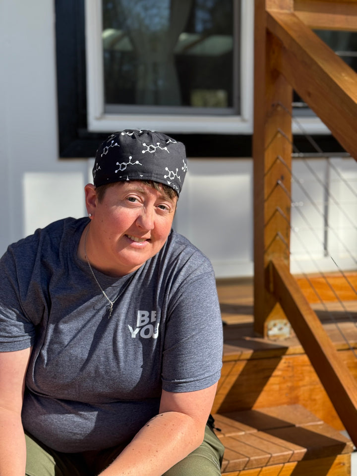 Front view of Dr. Beachgem wearing the Ladyspinedoc x Dr. Beachgem Code Cart Cap - Black Scrub Hat with White Epinephrine (Adrenaline) Molecule Design