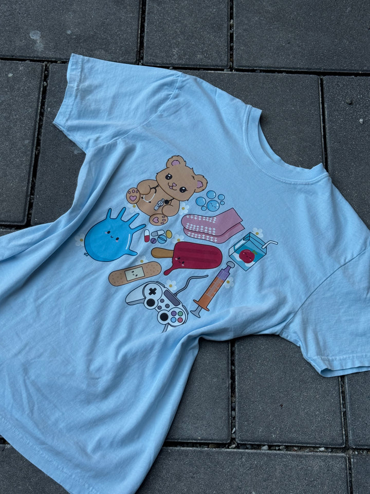 Flat lay of light blue Ladyspinedoc x Scrubhacks Pediatrics Collage Tee Shirt 