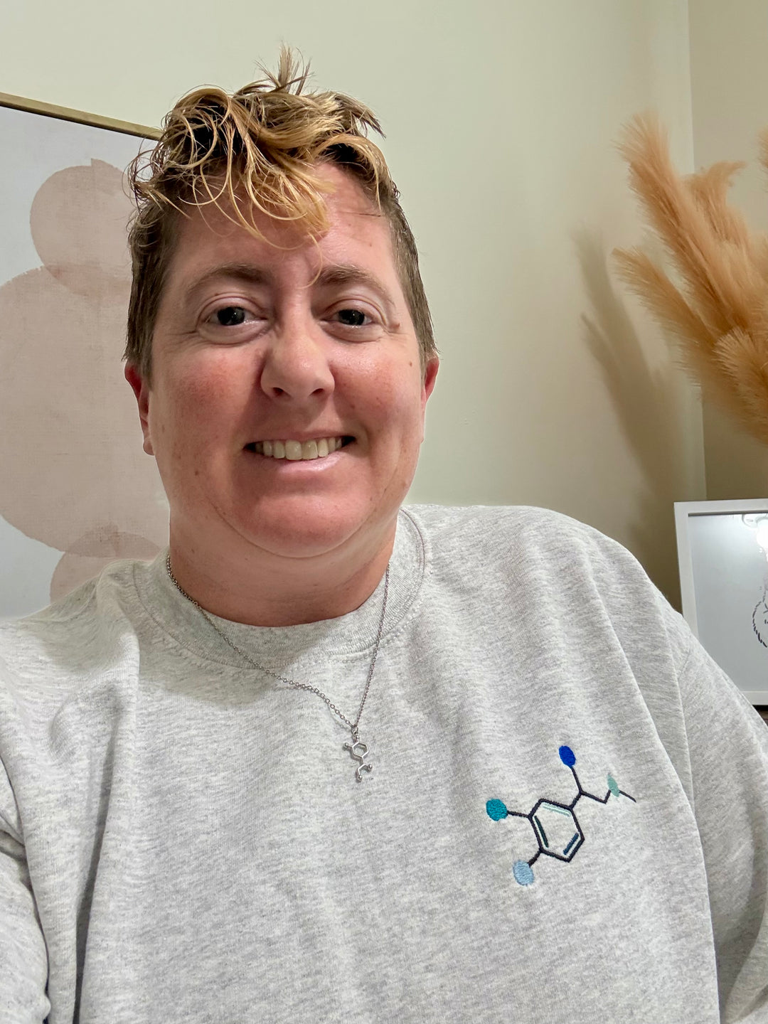 Dr Beachgem wearing the Ladyspinedoc x Dr. Beachgem Code Cart Crewneck Sweatshirt - Gray Shirt with Embroidered Epinephrine (Adrenaline) Molecule Design and Noradrenaline necklace. 