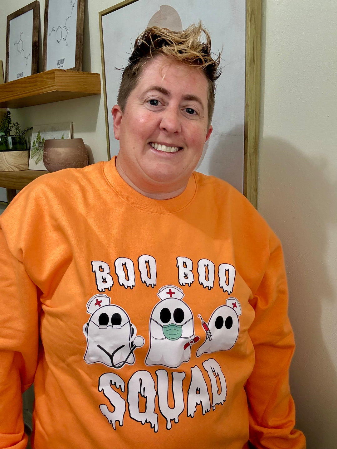 Dr. Beachgem wearing the orange Boo Boo Squad Crewneck Sweatshirt with ghost nurses
