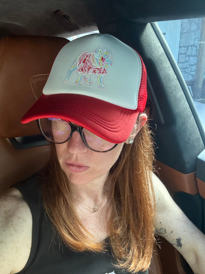 Ladyspinedoc wearing the Chan Art red snapback trucker hat with multicolor mascot graphic and foam front panel.